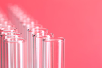 Close up laboratory test tubes on red background