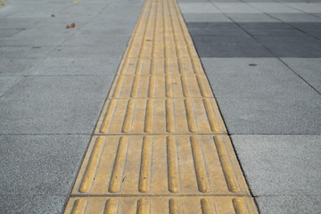 Tactile paving on footpath for blind pedestrians