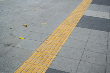 Tactile paving on footpath for blind pedestrians
