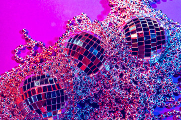 Shiny small disco balls sparkling in a beautiful purple light. Disco party concept