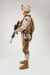 Studio shoot of modern infantry soldier, U.S. marine rifleman in combat uniform, helmet and body armor