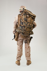 Portrait of a young American US Marine Corps soldier over grey background