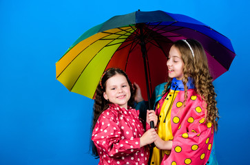 Be rainbow in someones cloud. Walk under umbrella. Kids girls happy friends under umbrella. Rainy weather with proper garments. Happy childhood. Bright umbrella. It is easier to be happy together