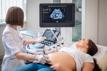 Pregnant woman on utltrasonographic examination at hospital - obrazy, fototapety, plakaty