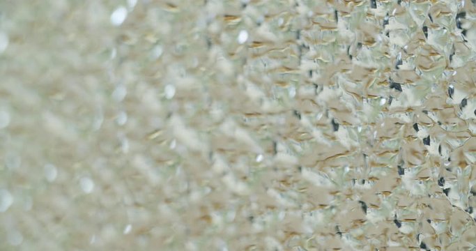 camera pan and rack focusing over an shattered glas, that consists of many geometric patterns.