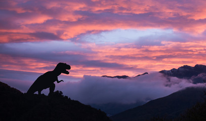 Silhouette of a tyrannosaurus rex at sunrise in the cretaceous era