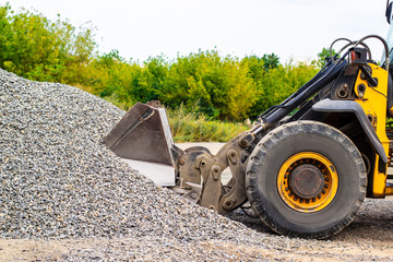 Unload bulk cargo with of the cargo railway platform in the mining quarry