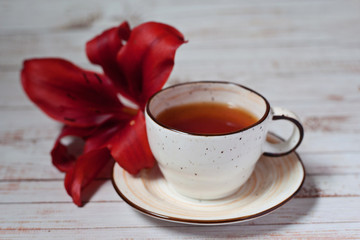 cup of tea with flowers on wooden table