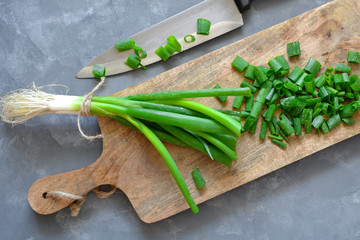 Fresh sliced chives on a wooden board
