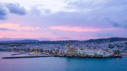 Naklejka premium Sitges Barcelona Spain. Epic pink sunset. Aerial view from the sea to the city
