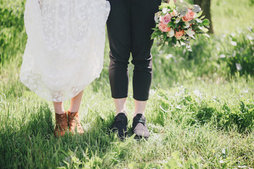 Bride and groom feet close up. Rustic wedding concept.