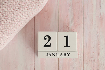 21 January Date on Cubes. Date on painted pink wood, next to baby blanket. Theme of baby due dates and birth dates.