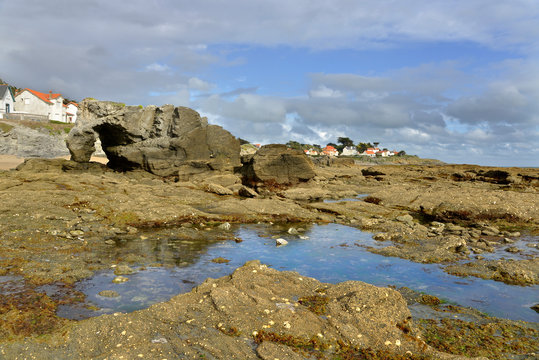 Rocky coast with the pierced rock at Pr&eacute;failles, a commune in the Loire-Atlantique department in western France.