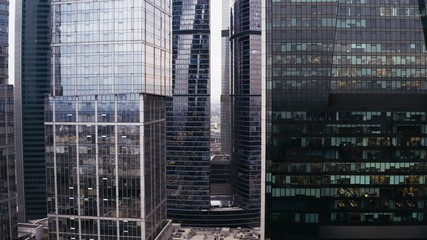 Fototapeta na wymiar Glass and concrete skyscrapers, business centers. aerial flight.