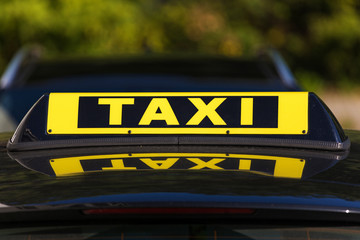 Taxi sign on roof of black cab