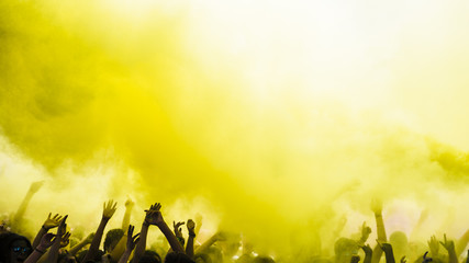 Explosion of yellow holi color over the crowd