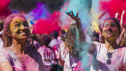 Happy young women playing with holi colors