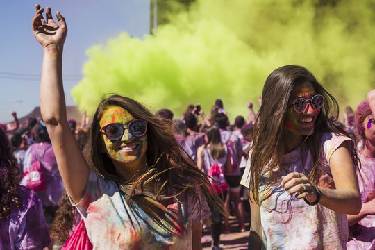 Smiling young women dancing in the holi festival