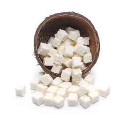 Coconut cubes, pieces, healthy sliced and diced snacks with shell isolated on white background