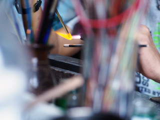 Process of glass bead at work. Glass Artist in his workshop