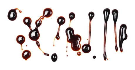 Spilled soy sauce, isolated on white background, top view