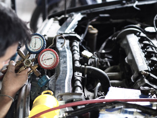Fototapeta na wymiar Pressure gauges with colorful pressure hose. Maintenance car air condition system.
