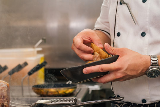 Close-up image of chef holding bowl and potato, copy space.