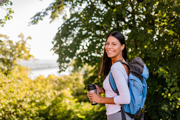 Portrait of a cheerful young woman on active vacation in nature.