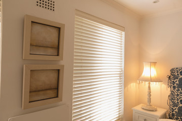 Wall frames near window blinds at home