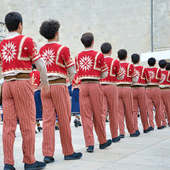 Dancers dancing and wearing one of the traditional folk costume from Armenia.