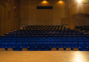 Naklejka premium Auditorium with all lights on with blue chair around