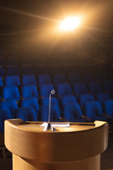 Empty auditorium with podium and speaker on stage 