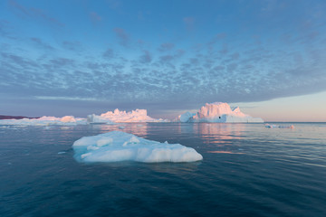 Huge icebergs of different forms in the Disko Bay, West Greenland. Their source is by the...