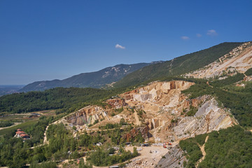 Obraz premium Air view of a marble quarry. Panoramic view of the extraction of marble in the quarry. Technique in the marble quarry of Brescia, Italy. Open pit mine.
