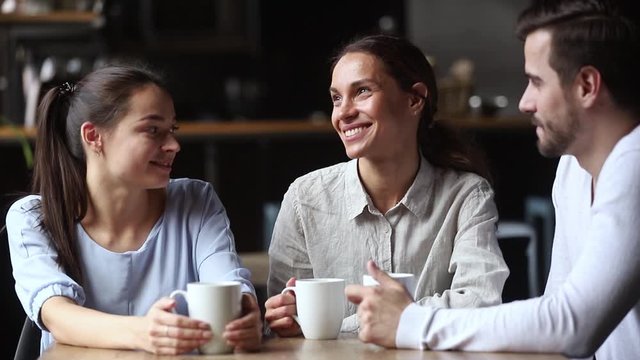 Diverse friends drinks tea talking spending time in cafe