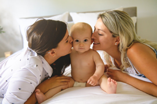 Two Lesbian Mother And Baby On Bed Having Fun