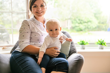 mother playing with her baby in the livingroom