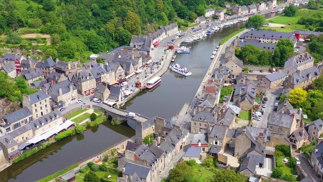 Aerial over the pretty town of Dinan, France with highway bridge.
