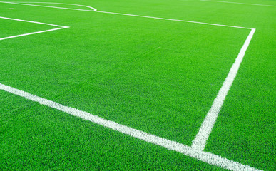 Fototapeta na wymiar Artificial green grass with white stripe on sports fields for soccer and football.