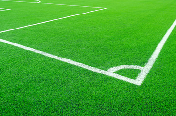 Fototapeta na wymiar Artificial green grass with white stripe on sports fields for soccer and football.