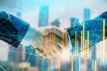 Fototapeta na wymiar Double exposure of financial chart and world map on cityscape background with two businessmen handshake. Concept of international investment
