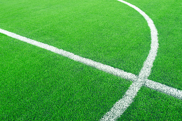 Obraz premium Artificial green grass with white stripe on sports fields for soccer and football.