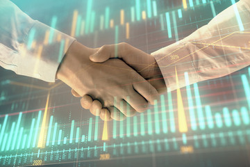 Fototapeta na wymiar Multi exposure of forex graph on abstract background with two businessmen handshake. Concept of success on stock market