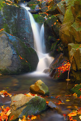 Fototapeta na wymiar small waterfall on mountain brook
