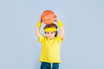 Basketball training. Sport game. Kid activities. Little basketballer. Sports equipment. Active sports lifestyle. Cute boy playing basketball. Enjoy sport game. Child boy in sportswear throws ball.