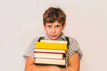 teen boy with books in his hands on white background