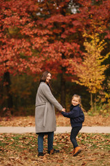 Fototapeta premium Two sisters walk in the park in autumn time. Childhood. season and people consept-happy family. Portrait of happy sisters in forest