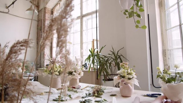 Panning of floristic studio interior in rustic style