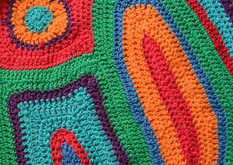 Fototapeta na wymiar Free form knitting crocheting texture background with cotton yarn of bright colors