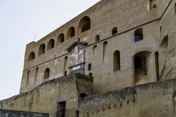 Naples, Italy Medieval fortress Sant Elmo facade. External day view of Saint Elmo Castle overlooking Napoli on the hill of Vomero, with outer wall fortification & Entry Gate with Imperial Eagle above.